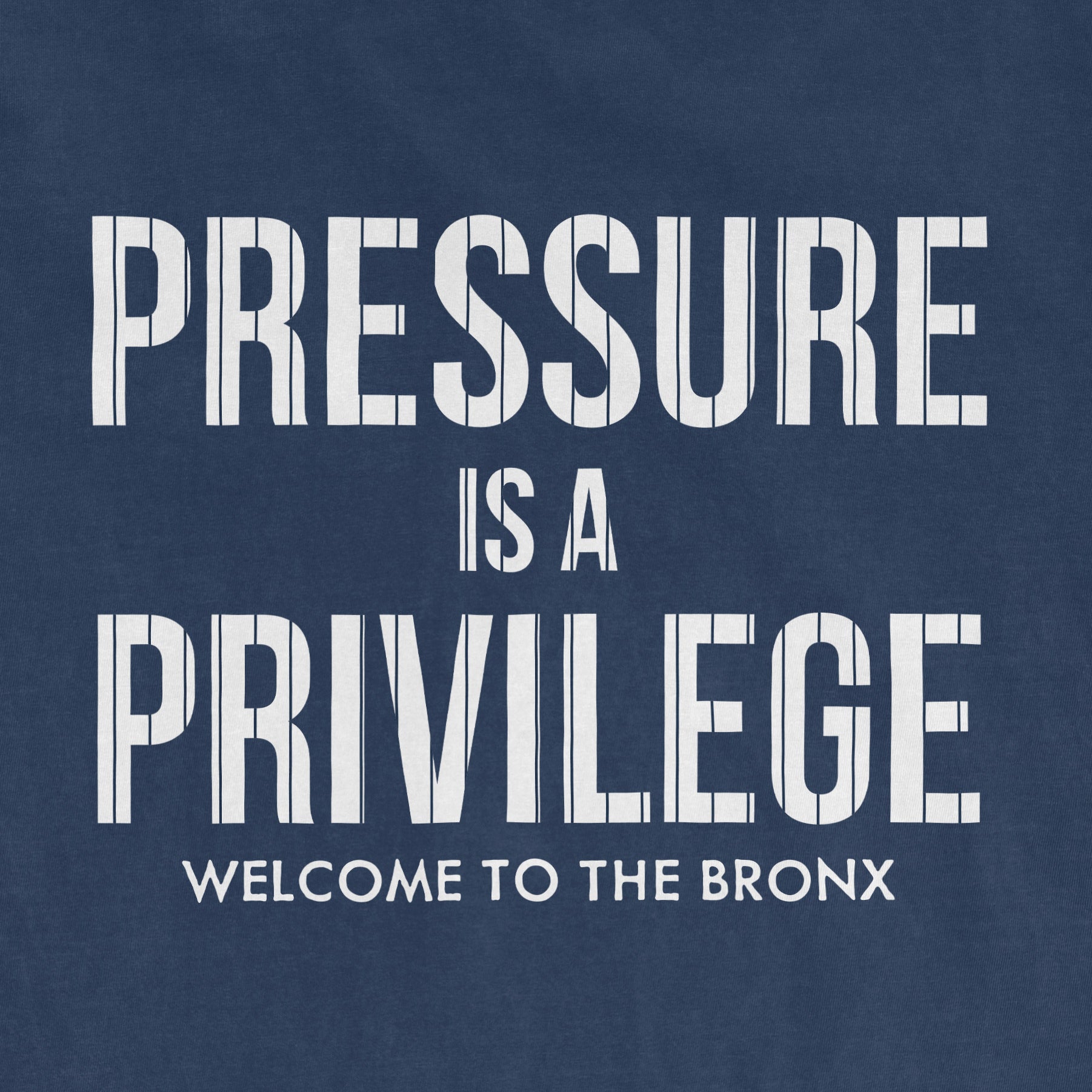 Blue T-shirt with white text reading "Pressure is a Privilege. Welcome to the Bronx." emphasizing resilience and pride.