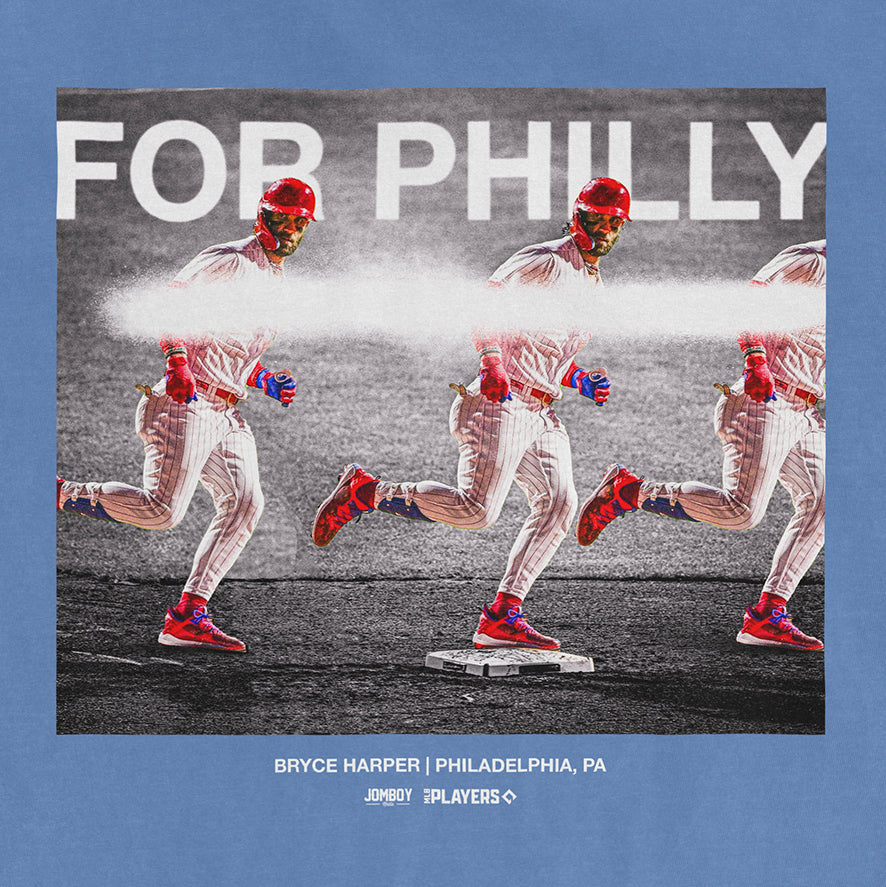 Bryce Harper "For Philly" Comfort Colors T-shirt featuring a graphic of Harper running with a spray of white paint, on a blue background.