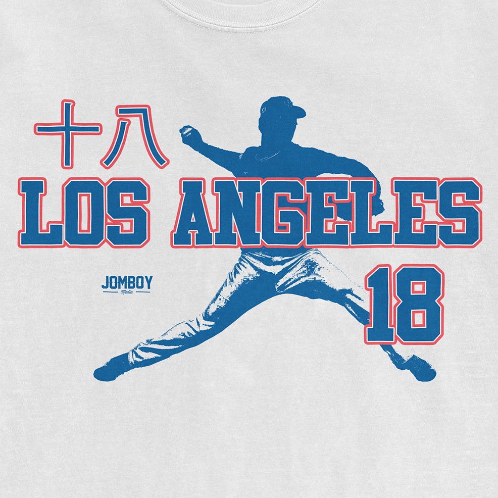White Comfort Colors tee featuring a blue graphic of a baseball player, "Los Angeles," "18," and "JomboY" text.