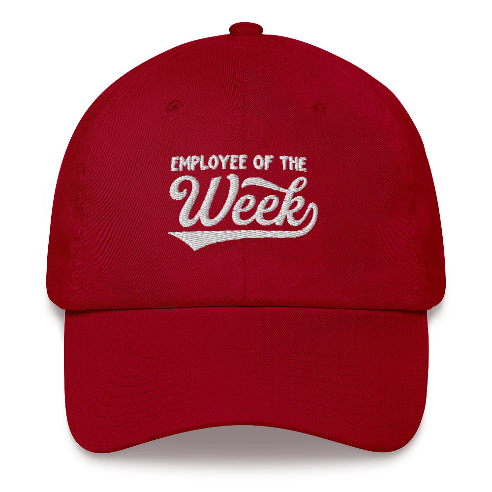 Red dad hat with white embroidered text reading "Employee Of The Week" on the front.